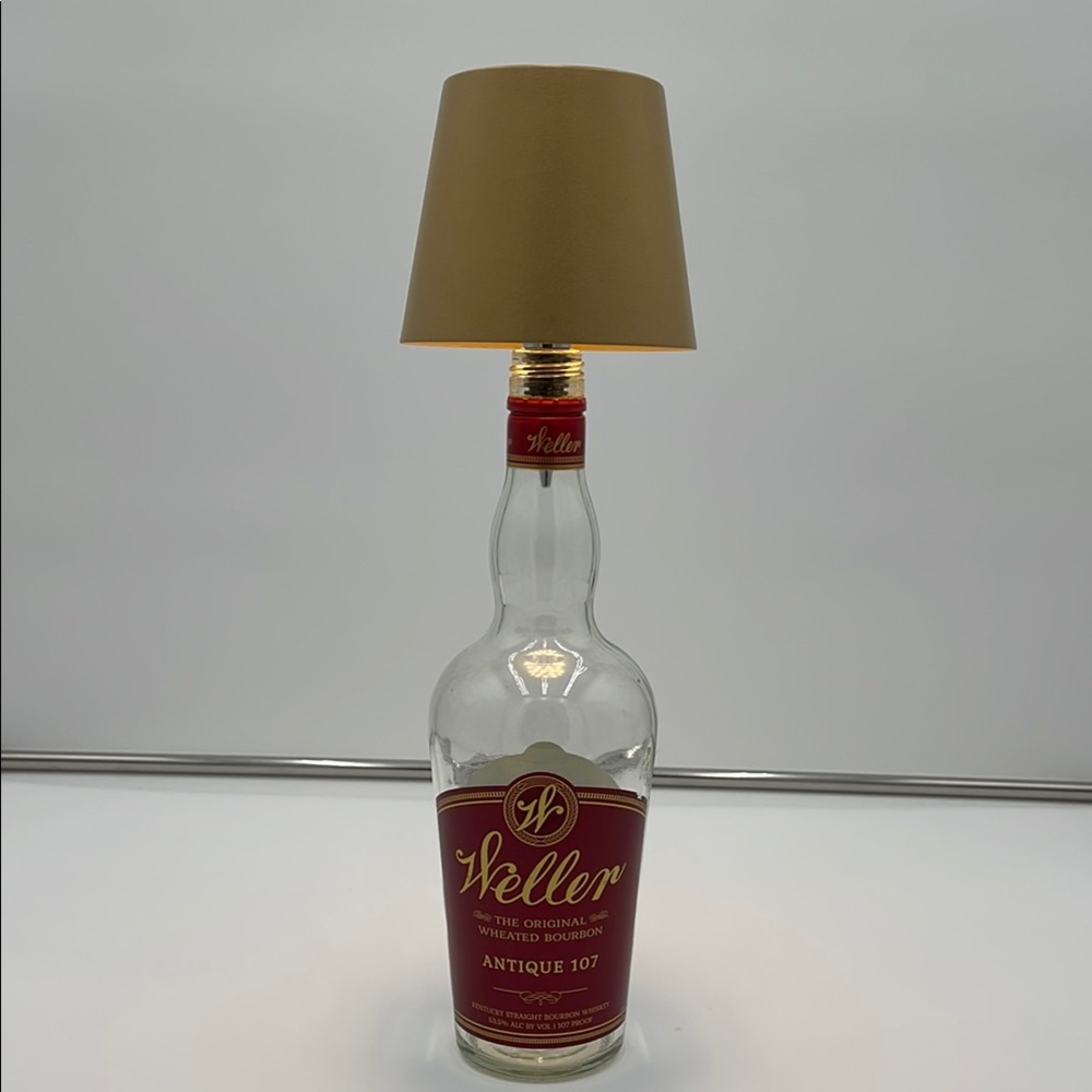 Antique 107 Bottle Lamp with gold shade.